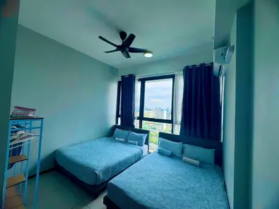 a bedroom with two beds and a ceiling fan at cozy 3BR family suites 10pax in Jelutong