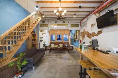 a living room with a couch and a staircase at My Guesthouse 109 - SELF CHECK IN in George Town
