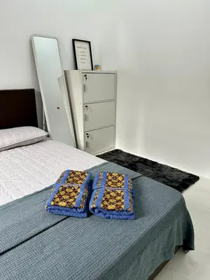 two trays of food are sitting on a bed at Pitaloka The Lakes Homestay in Batu Gajah