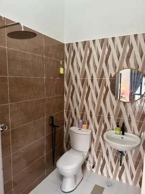 a bathroom with a toilet and a sink at Pitaloka The Lakes Homestay in Batu Gajah
