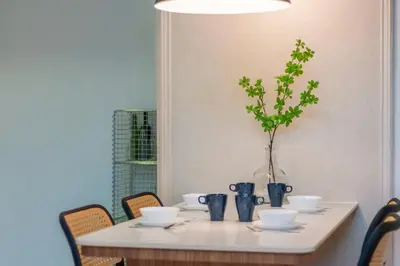a table with bowls and vases and a plant on it at Maritime Suites by Stellar ALV in Jelutong