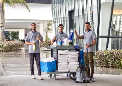 three men standing next to a cart with towels at Maritime Suites by Stellar ALV in Jelutong