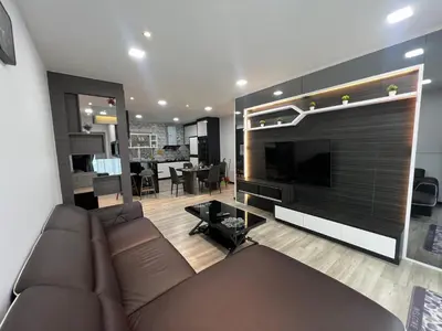 a living room with a couch and a flat screen tv at DanteQuintet Cameron Highlands in Tanah Rata