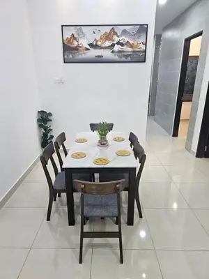 a dining room table with chairs and a vase on it at V-Home Taiping, 3BR, 7pax, Full Aircond, Wifi & Netflix, Early Bird Promo in Taiping