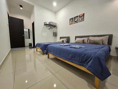 a bedroom with a large bed with a blue blanket at V-Home Taiping, 3BR, 7pax, Full Aircond, Wifi & Netflix, Early Bird Promo in Taiping