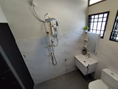 a bathroom with a shower and a sink at Homestay 39 Private Pool Perak in Tanjung Rambutan