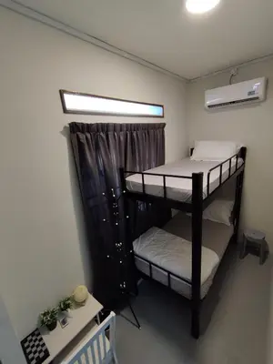 two bunk beds in a room with a window at Homestay 39 Private Pool Perak in Tanjung Rambutan