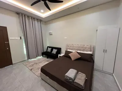 a bedroom with a bed and a ceiling fan at Rimbunan Padi Roomstay in Bagan Serai