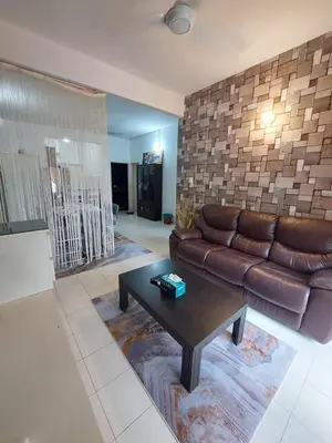 a living room with a couch and a coffee table at Alle Vacation Homes Tambun Ipoh in Ipoh