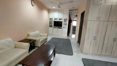 a living room with a couch and a table at Impiana Homestay in Kampong Kawak