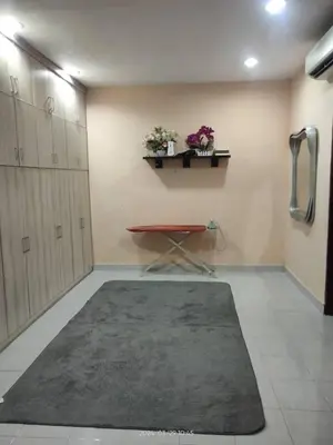 a room with a table and a rug in a room at Impiana Homestay in Kampong Kawak