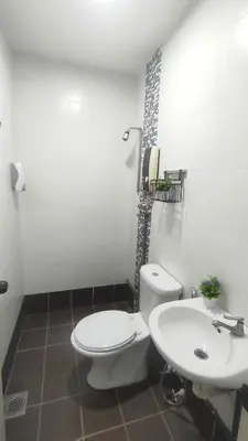 a bathroom with a white toilet and a sink at 33 HOMESTAY 4 Room 5 MINUTE TO LEANING TOWER in Teluk Intan