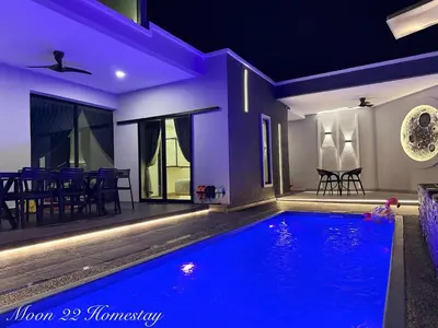 a swimming pool in a house at night at Moon22 Private Pool in Ipoh