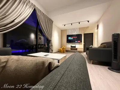 a living room with a couch and a tv at Moon22 Private Pool in Ipoh