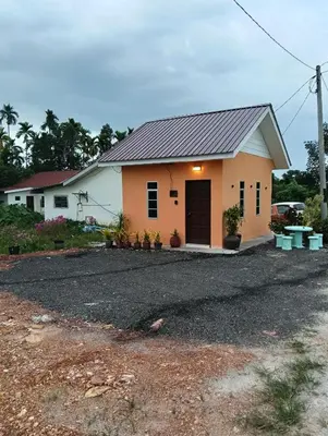 a house with a gravel driveway in front of it at D'Permata Roomstay Kampung Pelet in Kubang Semang
