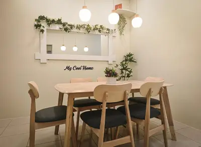 a dining room table with four chairs and a mirror at Natural Garden Stay in Cameron Highlands in Tanah Rata