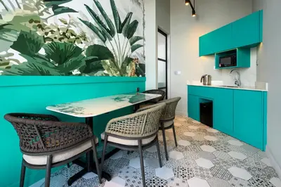 a dining room with a table and chairs at Fifth Avenue Hotel in George Town