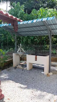 a concrete bench with a roof on top of it at D'Binjai Homestay & Roomstays Kuala Kangsar in Kuala Kangsar