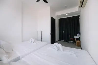 two beds in a hotel room with white sheets at Seaview Infinity Pool 2BR 2CP 8Pax Urban Suite 251 in George Town