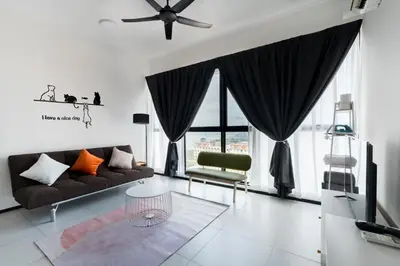 a living room with a couch and a ceiling fan at Seaview Infinity Pool 2BR 2CP 8Pax Urban Suite 251 in George Town