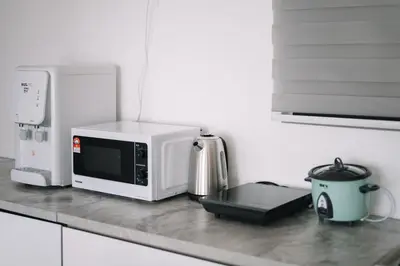 a kitchen counter with a microwave and a coffee pot at Seaview Infinity Pool 2BR 2CP 8Pax Urban Suite 251 in George Town