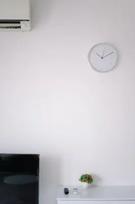 a clock on a white wall above a desk at Seaview Infinity Pool 2BR 2CP 8Pax Urban Suite 251 in George Town