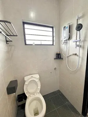 a bathroom with a toilet and a shower at Tpg Creek Lodge in Kamunting