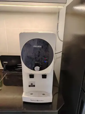 a blender sitting on a counter next to a refrigerator at Tpg Creek Lodge in Kamunting