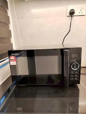 a microwave oven sitting on top of a wall at Tpg Creek Lodge in Kamunting