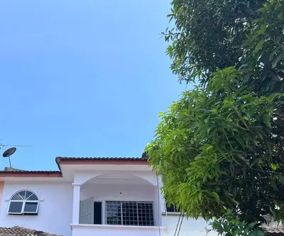 a white house with a window and a tree at Teratak Segar Bayu - Musslim Only Tanjong Malim Perak in TanjongMalim