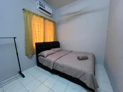 a small bedroom with a bed and a window at Teratak Segar Bayu - Musslim Only Tanjong Malim Perak in TanjongMalim