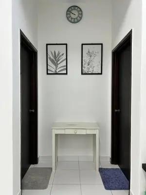 a room with two doors and a desk and a clock at ZN LODGE at KAMUNTING in Kamunting
