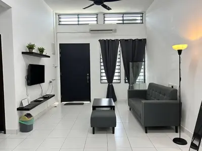 a living room with a couch and a tv at ZN LODGE at KAMUNTING in Kamunting