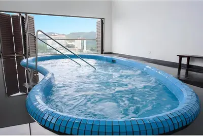 a large blue bath tub in a room with a window at Serene Japandi Family Retreat 2-7pax &Sunrise View in Brinchang