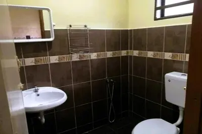 a bathroom with a toilet and a sink at NO DEPOSIT - BIG Home 2-sty Terrace Near World Theme Park Hot Springs & Night Park max 6person in Ipoh