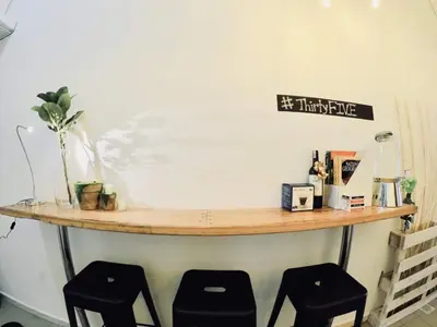a counter with two stools in a room at 35Mandalay at Georgetown 5 bedroom for 7-15 pax in George Town