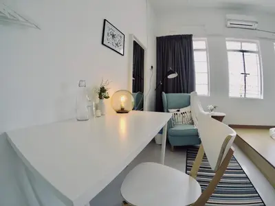 a living room with a white table and chairs at 35Mandalay at Georgetown 5 bedroom for 7-15 pax in George Town