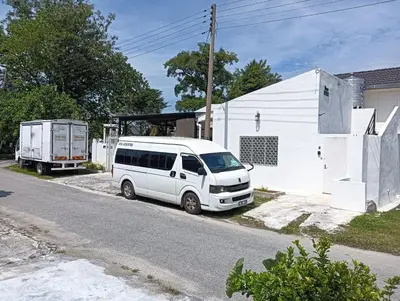 a white van parked on the side of a street at HT Home in Ipoh