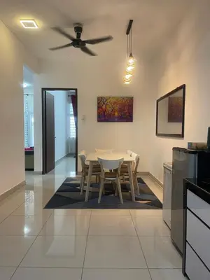 a kitchen and dining room with a table and chairs at Homestay Sakura in Padang Serai
