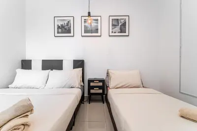 two beds sitting next to each other in a room at Serene Minimalist Family Retreat 2-7pax &Sunrise View in Brinchang