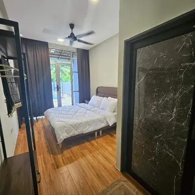 a bedroom with a bed in a room with a window at Sastred villa Mus'lim Only in Sungai Petani