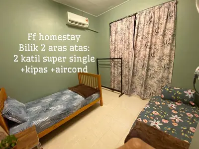 a bedroom with a bed and a couch and a window at FF Lunas Homestay in Lunas