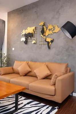 a living room with a couch and a world map on a wall at Serene Industrial Family Retreat 2-7pax &Sunrise view in Brinchang