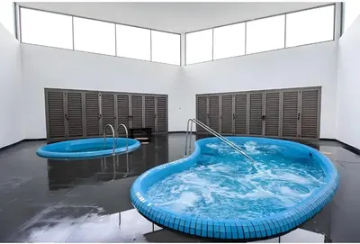 a large blue tub in a room with windows at Serene Industrial Family Retreat 2-7pax &Sunrise view in Brinchang