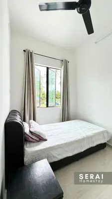 a bedroom with a bed and a window at SERAI Homestay in Gopeng