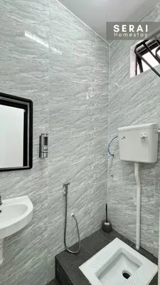 a bathroom with a sink and a toilet in it at SERAI Homestay in Gopeng