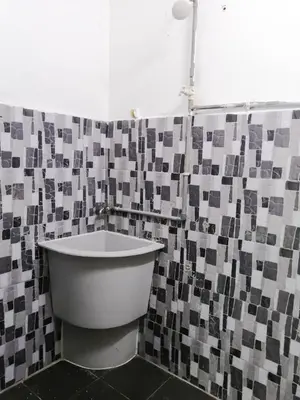 a bathroom with a tub and a tiled wall at SK Sweet Homestay SP Kedah in Sungai Petani