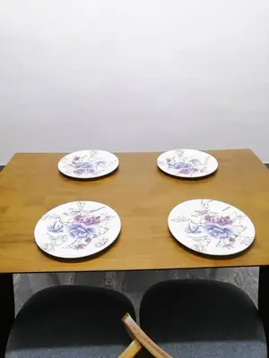 a wooden table with three plates on top of it at SK Sweet Homestay SP Kedah in Sungai Petani