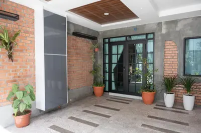 an entrance to a brick building with potted plants at Bricks Guesthouse in Tanah Rata