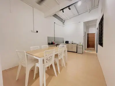 a dining room with a wooden table and white chairs at Cozy10perwira#6pax#Netflix#neariconcity&iconicpoint in Simpang Ampat
